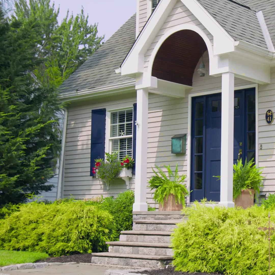 Shingled Fairfield County home with a freshly painted navy front door