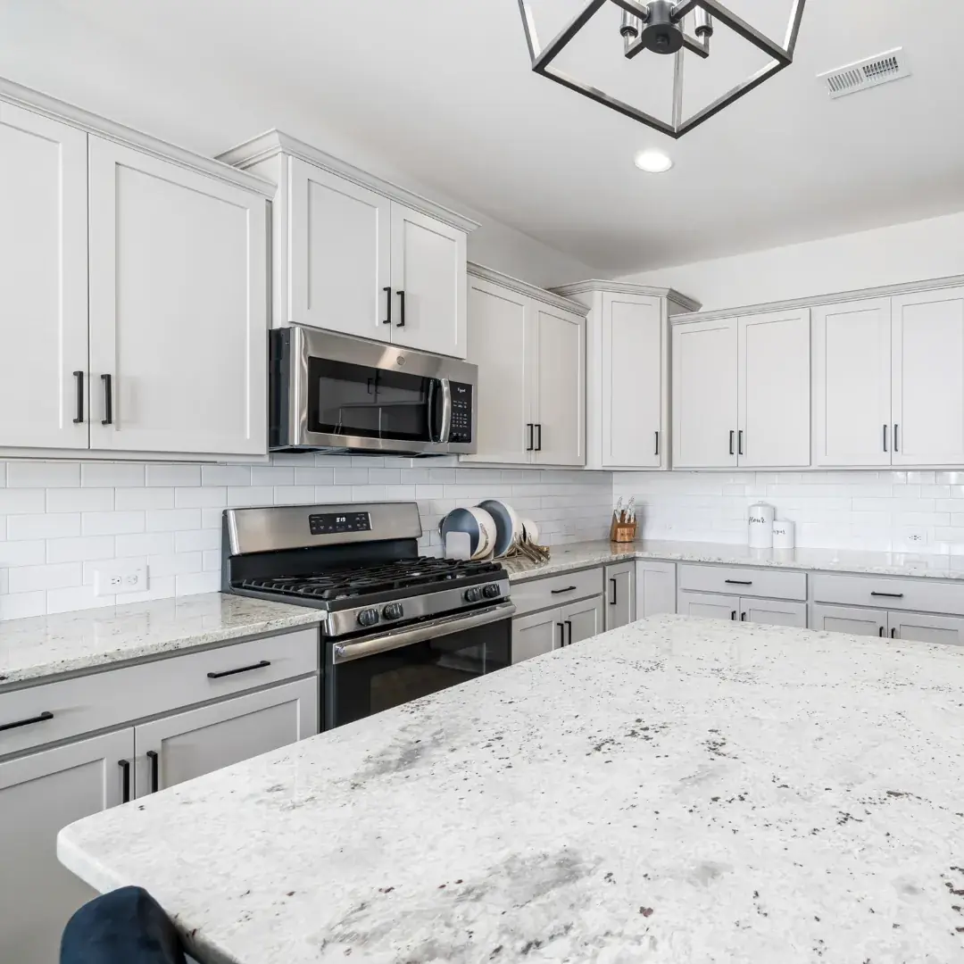Kitchen with freshly painted white cabinetry