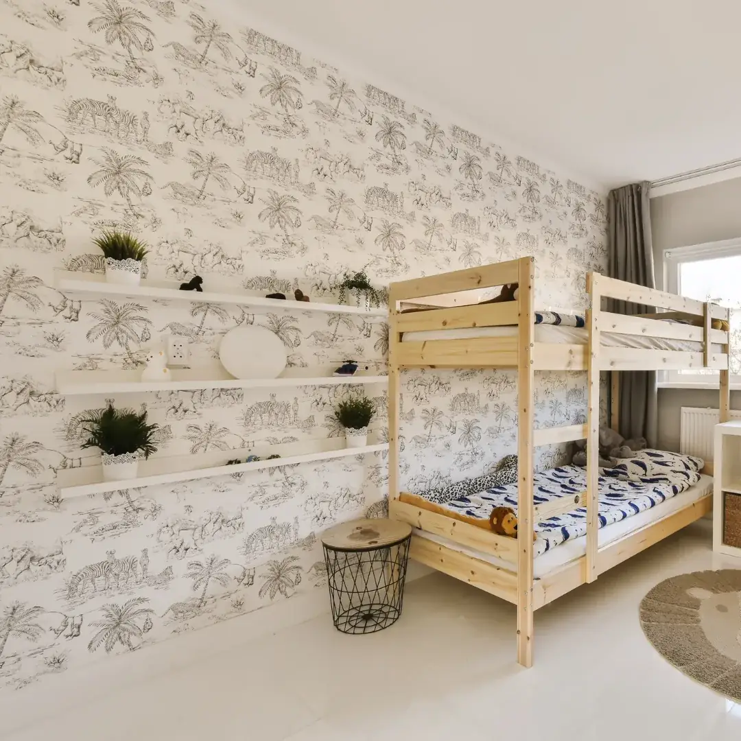 Children's room with patterned wallpaper installed on the feature wall